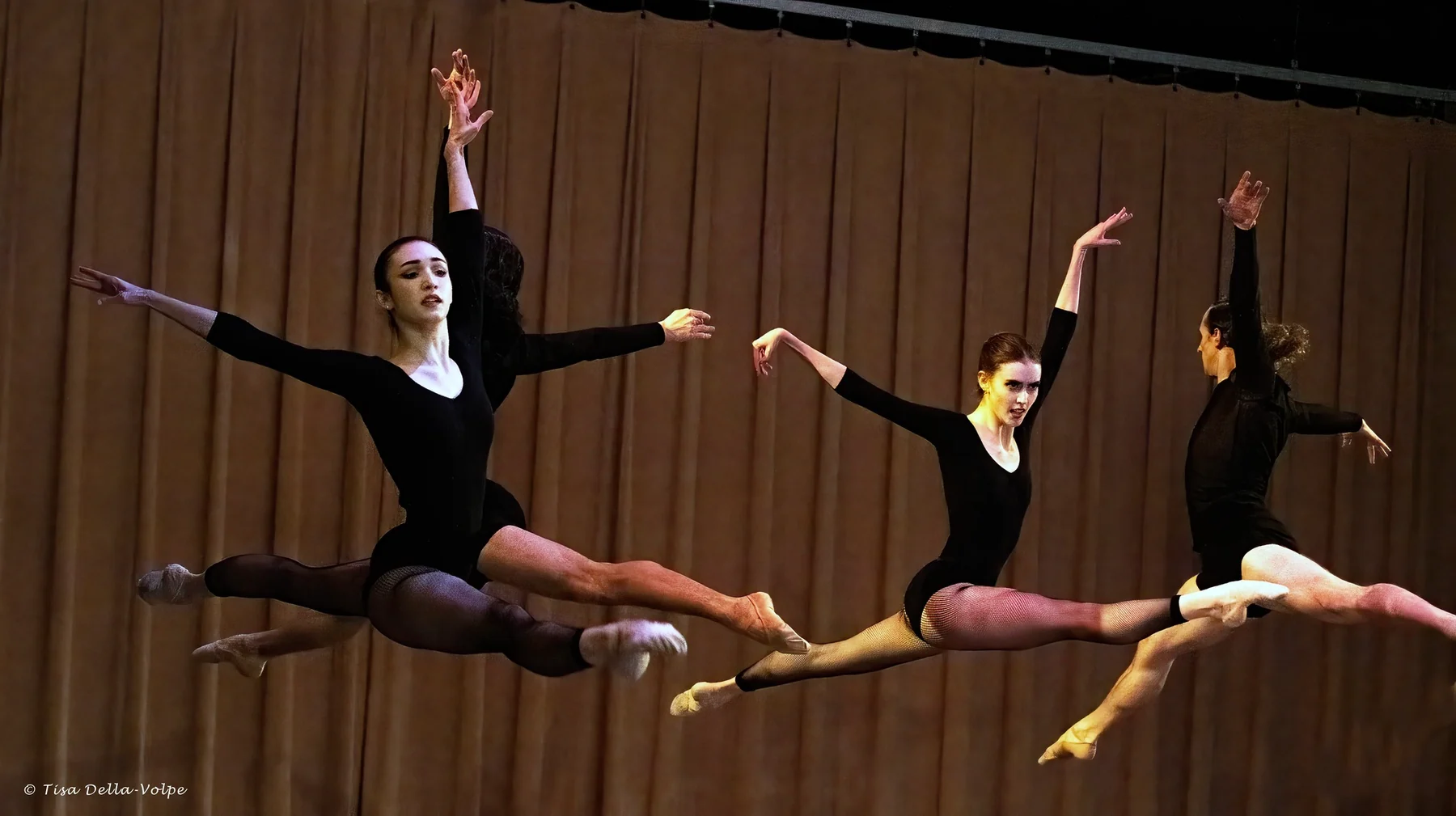 Dancers performing synchronized leaps