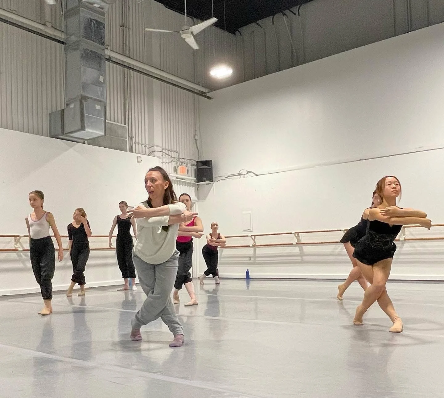 Maeghan McHale leading dancers through choreography in a studio