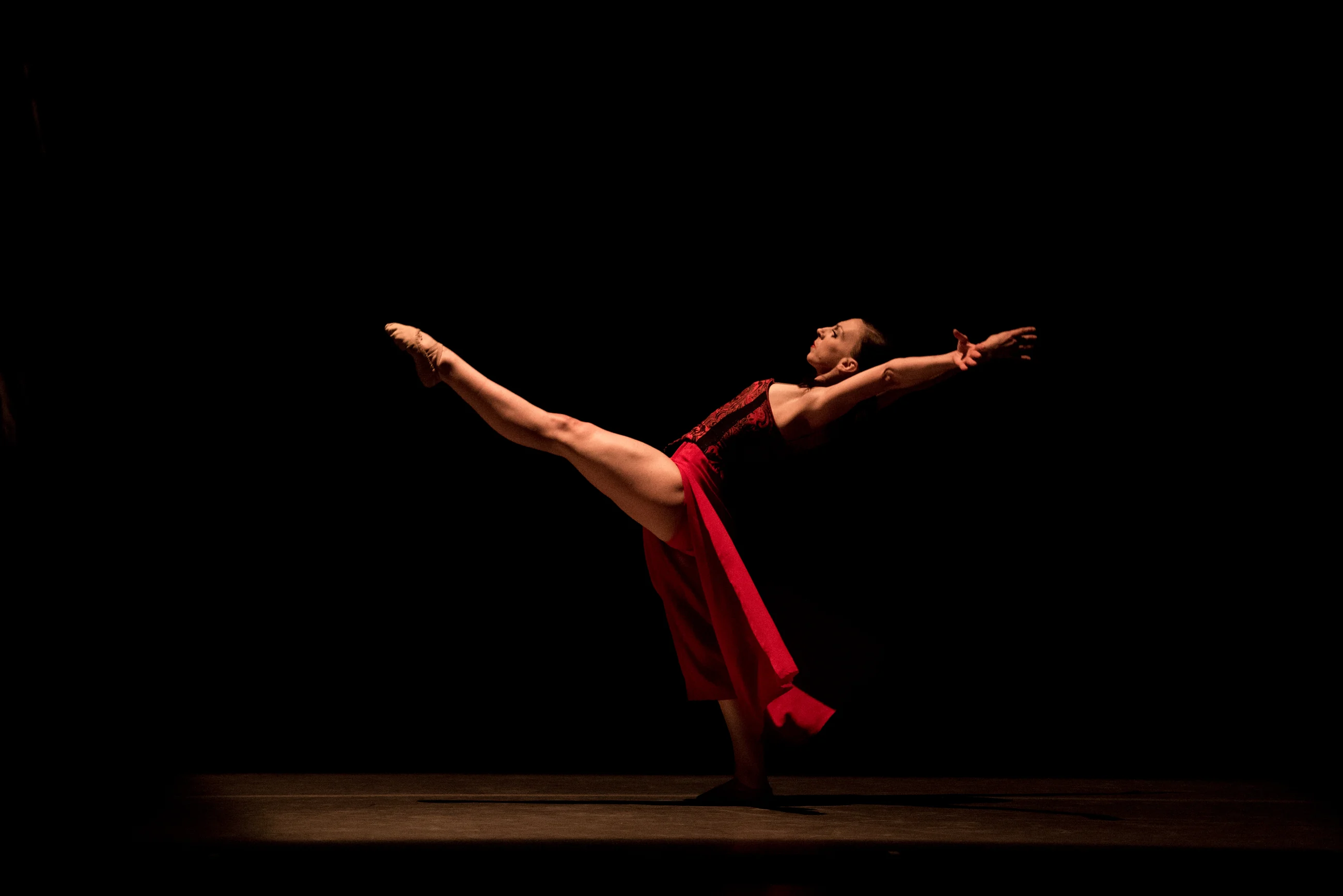 Maeghan McHale performing onstage in a red costume