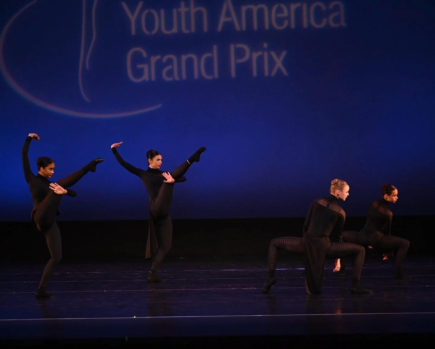 Contemporary dancers on a Youth America Grand Prix stage