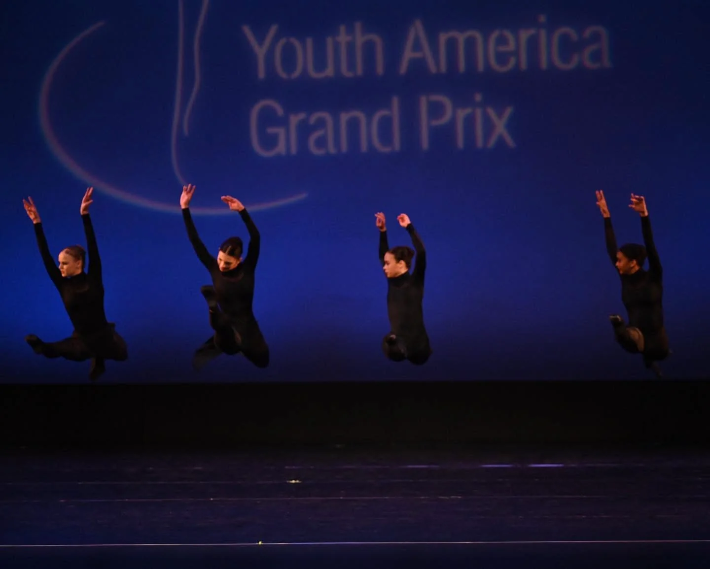 Contemporary ensemble performing in black costumes